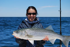 Captain Elena Rice with Keeper Striped Bass
